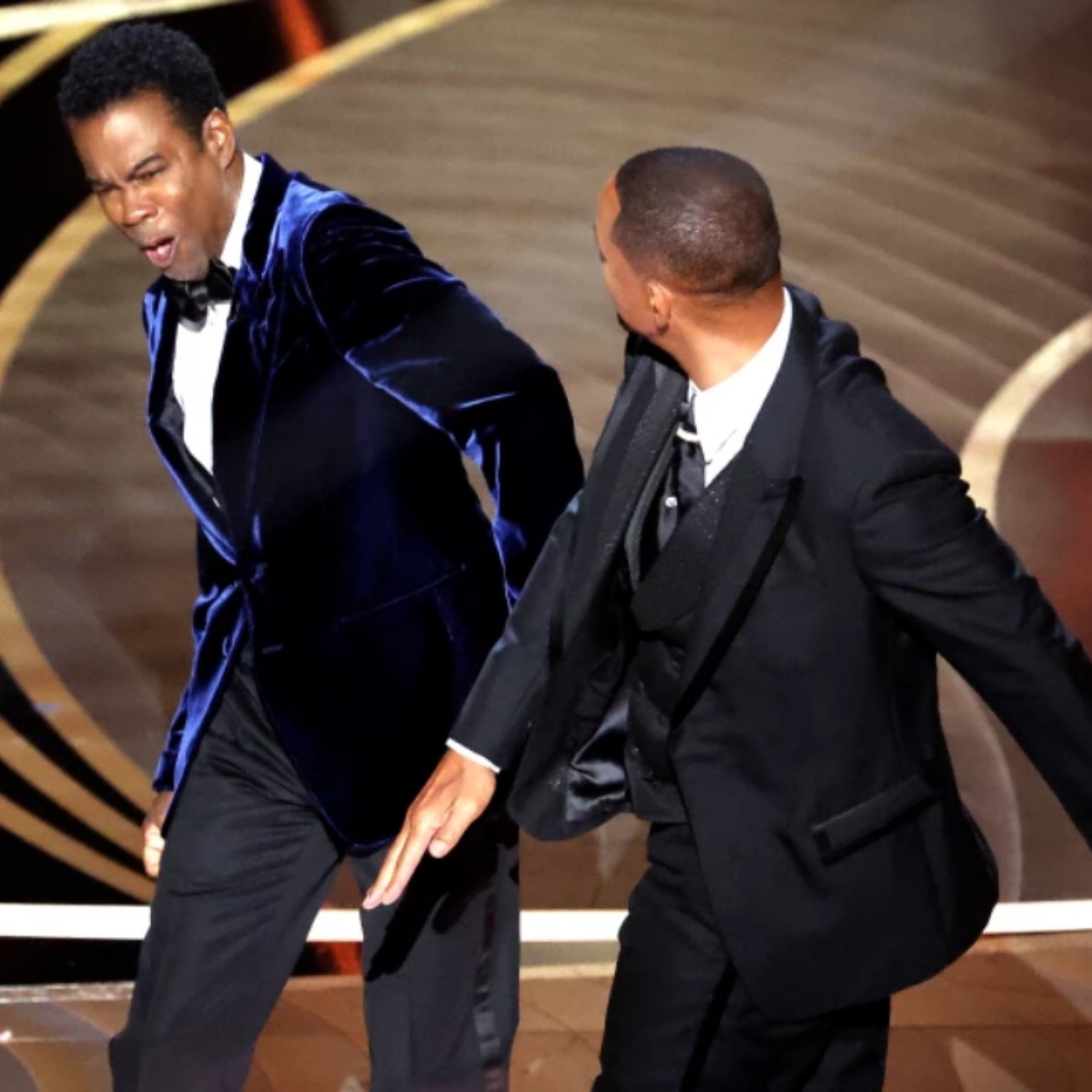 Will Smith slaps Chris Rock on stage of Oscars 2022.